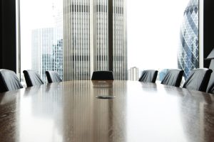 Empty Conference room with long table and chair with large glass windows background waiting for mediation.