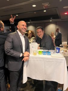 Attendees at the table with MediationWorks Giveaway Bag with cool swag at the Broward County Bar Association's Join Social