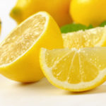 A group of yellow lemons whole and cut