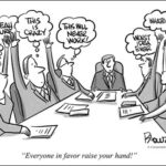 people around table all sharing thoughts with hands in the air