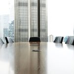 Empty Conference room with long table and chair with large glass windows background waiting for mediation.