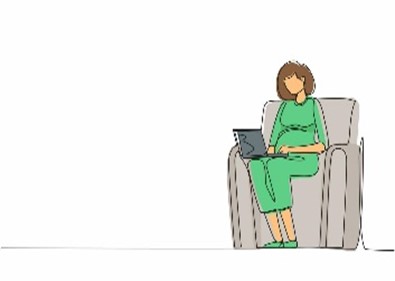 a woman in green sitting in a chair with a laptop on her lap.