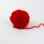 Red yarn isolated on white background