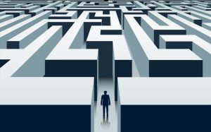 Businessman stands in front of a labyrinth. Problem solving and business opportunities. Vector illustration