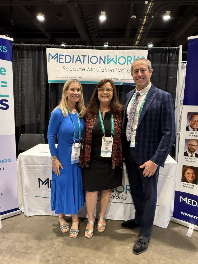 Joanne Luckman, Eric Luckman and Brenda Pagliaro at booth at 2026 Wind Conference